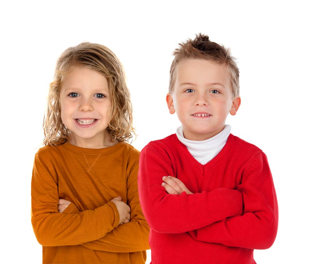Two happy children with fair hair isolated on a white background. Full portrait