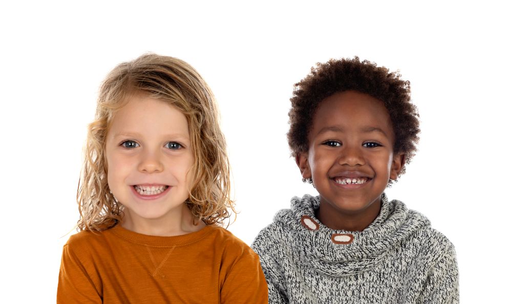 Two children looking at camera isolated on a white backround