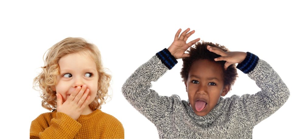 Two small children covering their mouths isolated on a white background