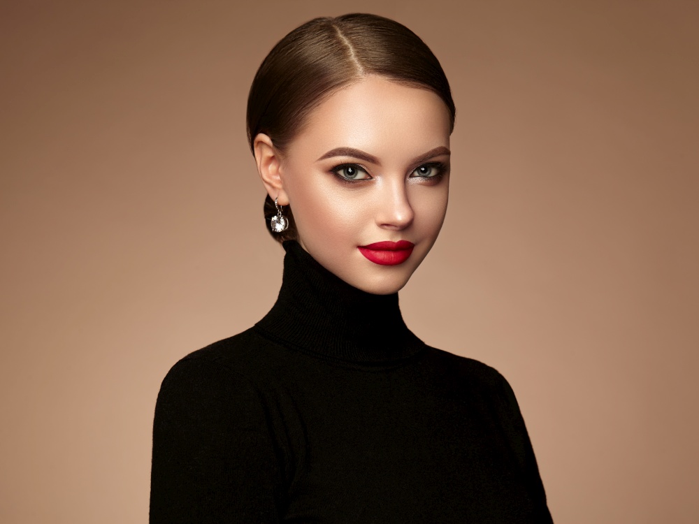 Beautiful Young Woman with Clean Fresh Skin. Perfect Makeup. Beauty Fashion. Red Lips. Cosmetic Eyeshadow. Smooth Hair. Girl in Black Turtleneck