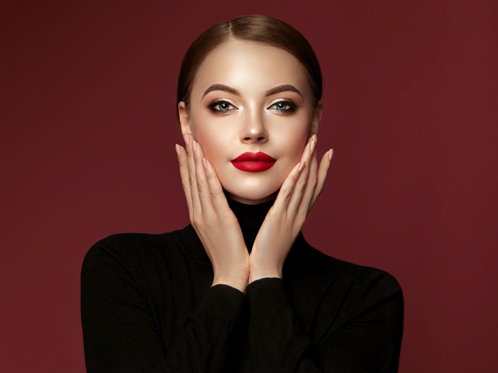 Beautiful Young Woman with Clean Fresh Skin. Perfect Makeup. Beauty Fashion. Red Lips. Cosmetic Eyeshadow. Smooth Hair. Girl in Black Turtleneck