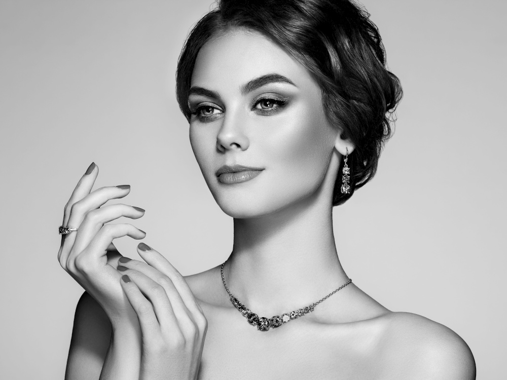Portrait beautiful woman with jewelry. Model girl with manicure on nails. Beauty and Accessories. Black and white photo
