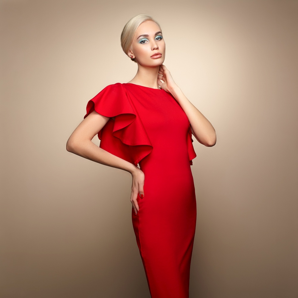 Fashion portrait of elegant woman with magnificent hair. Blonde girl. Perfect make-up. Girl in elegant red dress. Girl posing. Studio photo