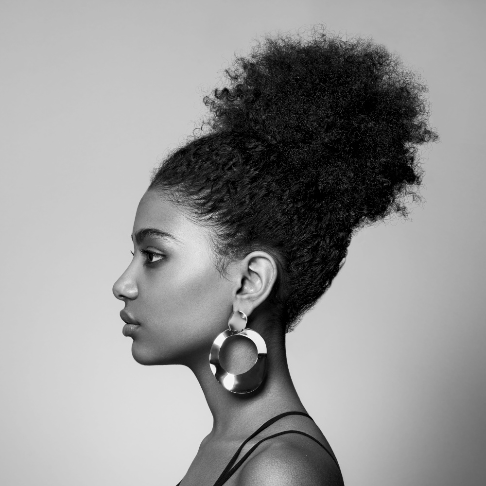 Beauty portrait of African American girl with afro hair. Beautiful black woman. Cosmetics, makeup and fashion. Fashionable black and white photography
