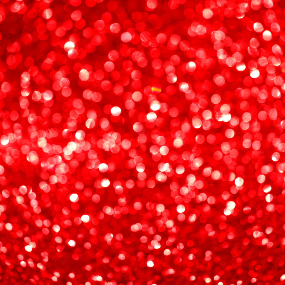 Red festive glitter background with defocused lights