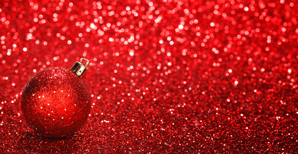 Red christmas ball over shiny glitter background