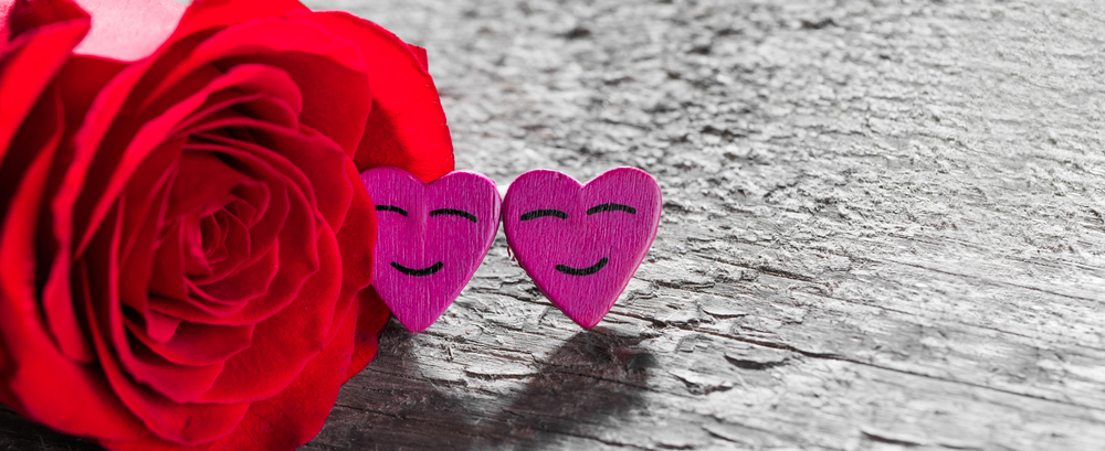 Red rose and decorative hearts over wooden background. Red rose and hearts