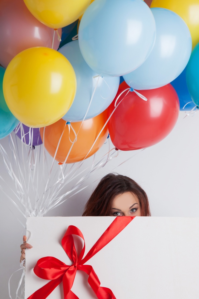 Young woman with balloons and big gift box. Woman with balloons and gift