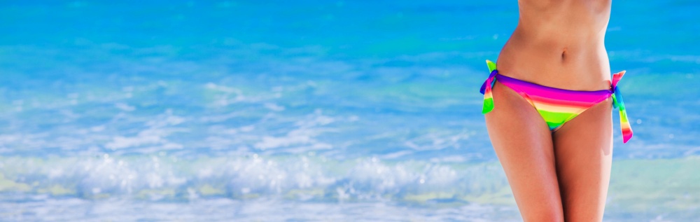 Woman with perfect body in bikini over tropical sea background. Woman in bikini