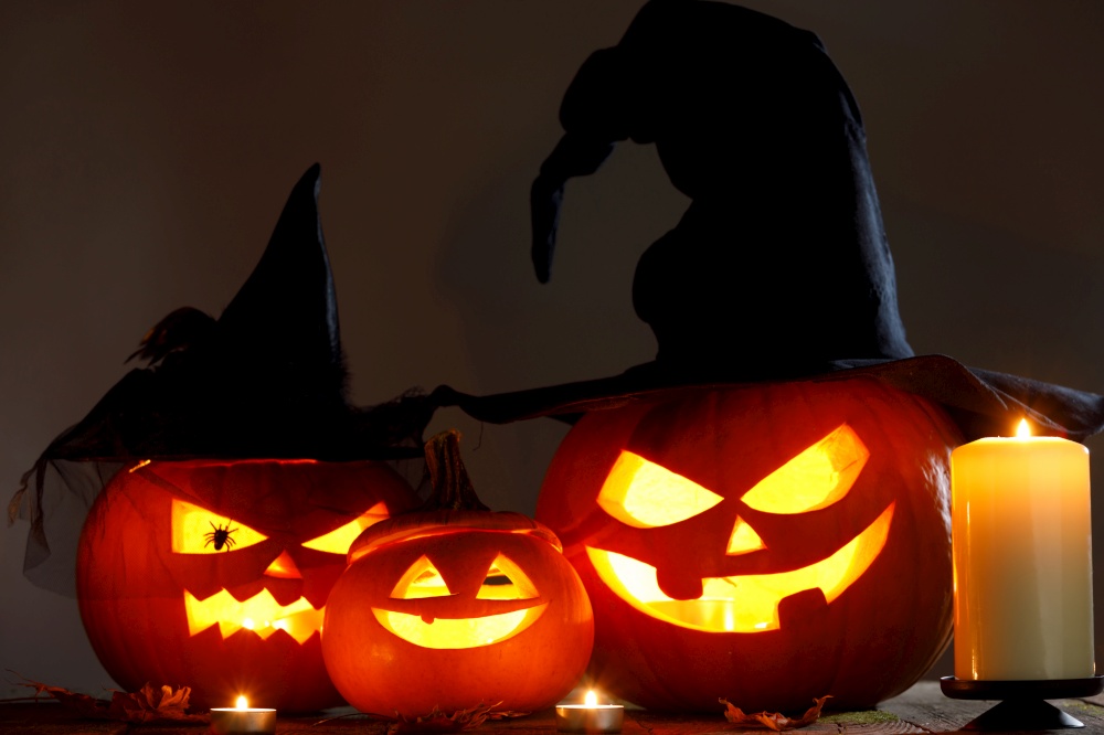 Still life of Halloween pumpkin lanterns pumpkins and hats decoration in candle light. Halloween pumpkin lanterns
