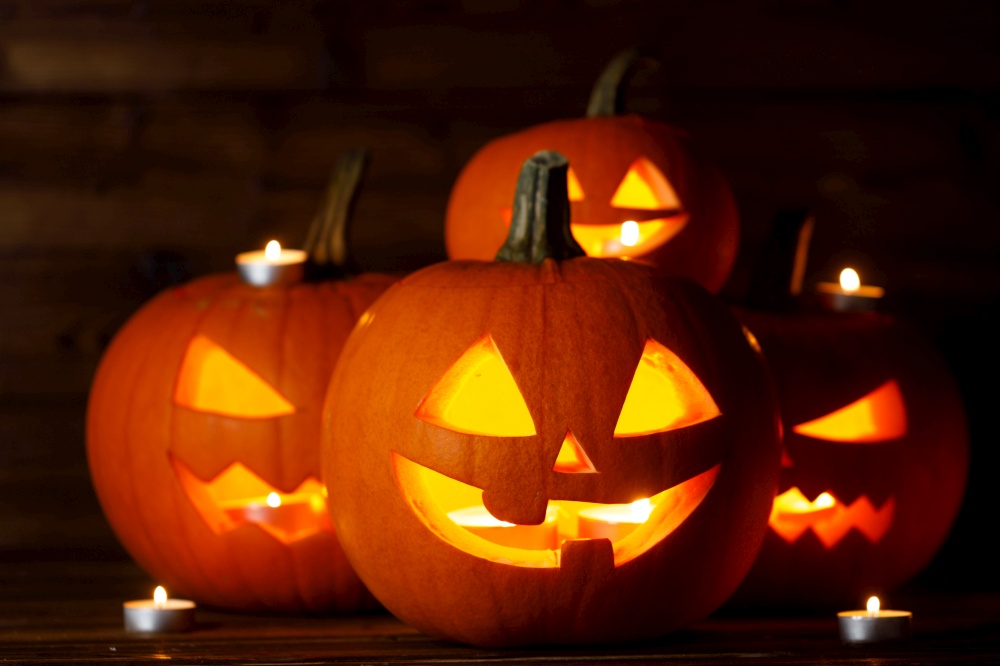 Halloween Jack O Lantern pumpkins and burning candles traditional decoration. Halloween lantern pumpkins candles