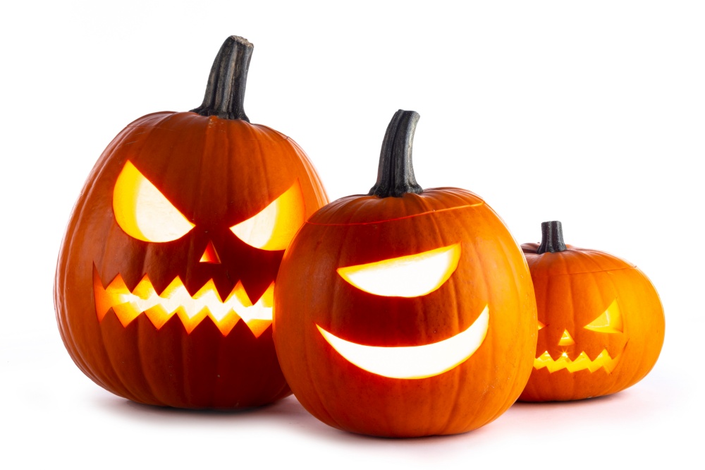 Three Halloween glowing funny lantern pumpkins isolated on white background. Three Halloween lantern pumpkins