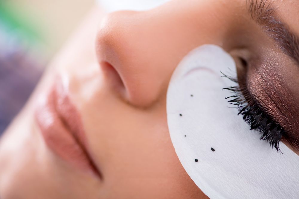 Young woman getting eyelash extension