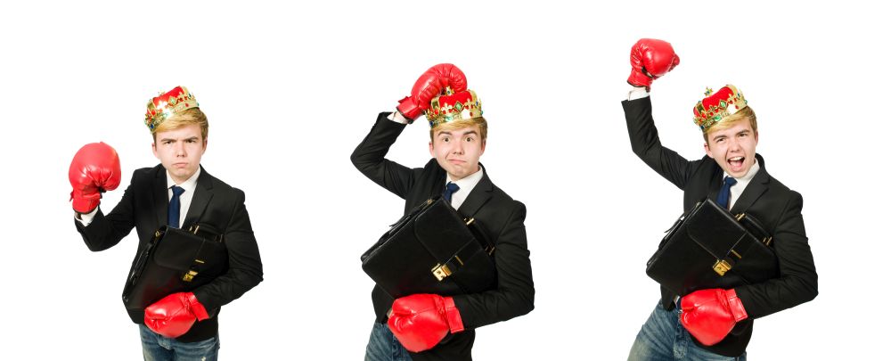 Funny businessman with crown and boxing gloves