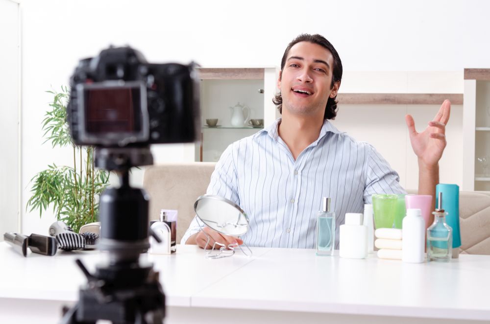 Young handsome man recording his blog in hygiene concept