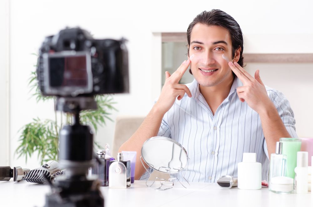 Young handsome man recording his blog in hygiene concept