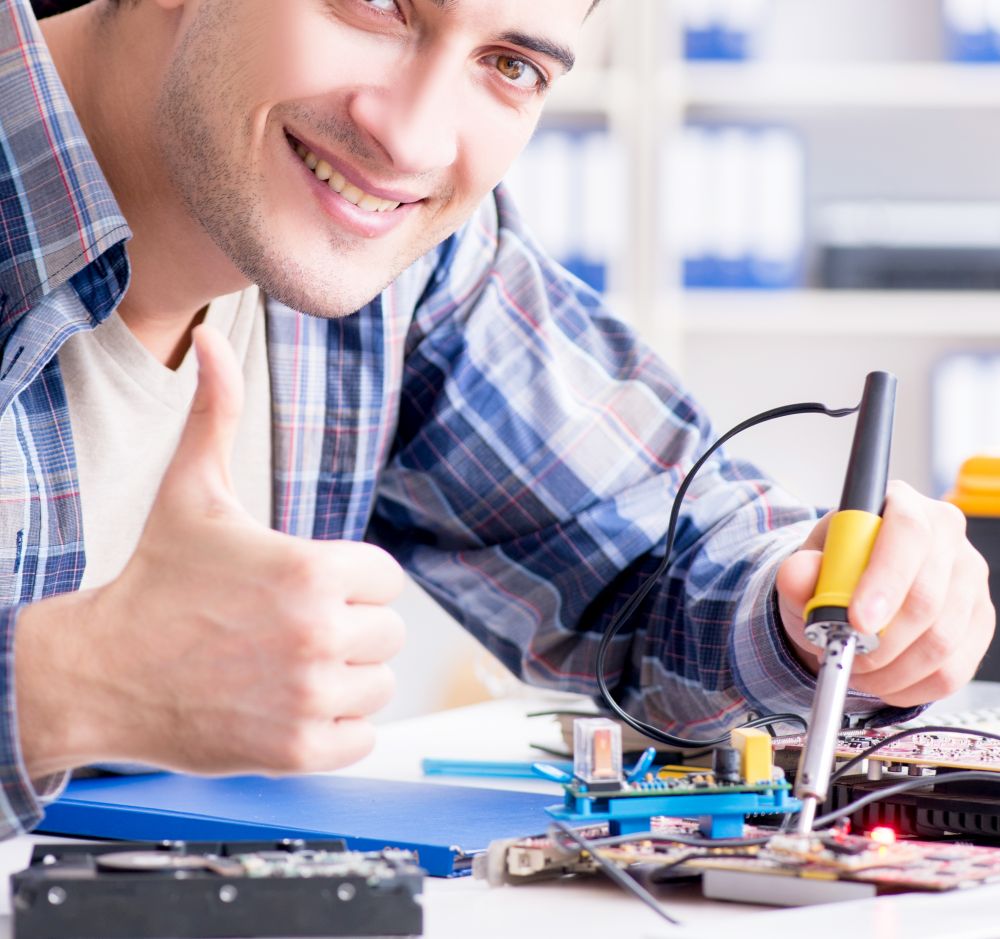 The professional repairman repairing computer in workshop. Professional repairman repairing computer in workshop