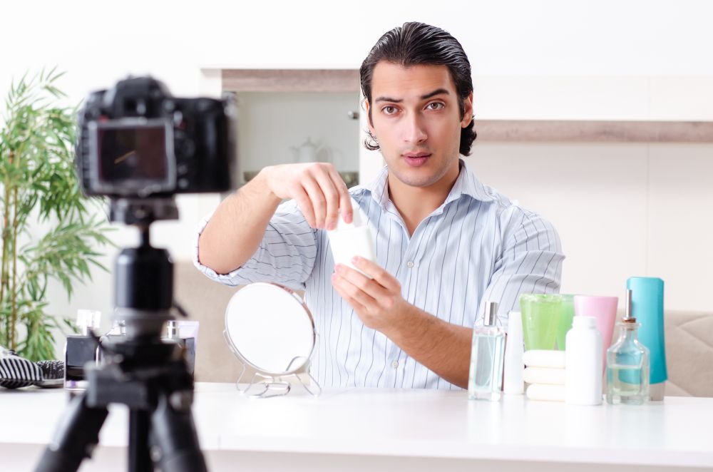 The young handsome man recording his blog in hygiene concept . Young handsome man recording his blog in hygiene concept