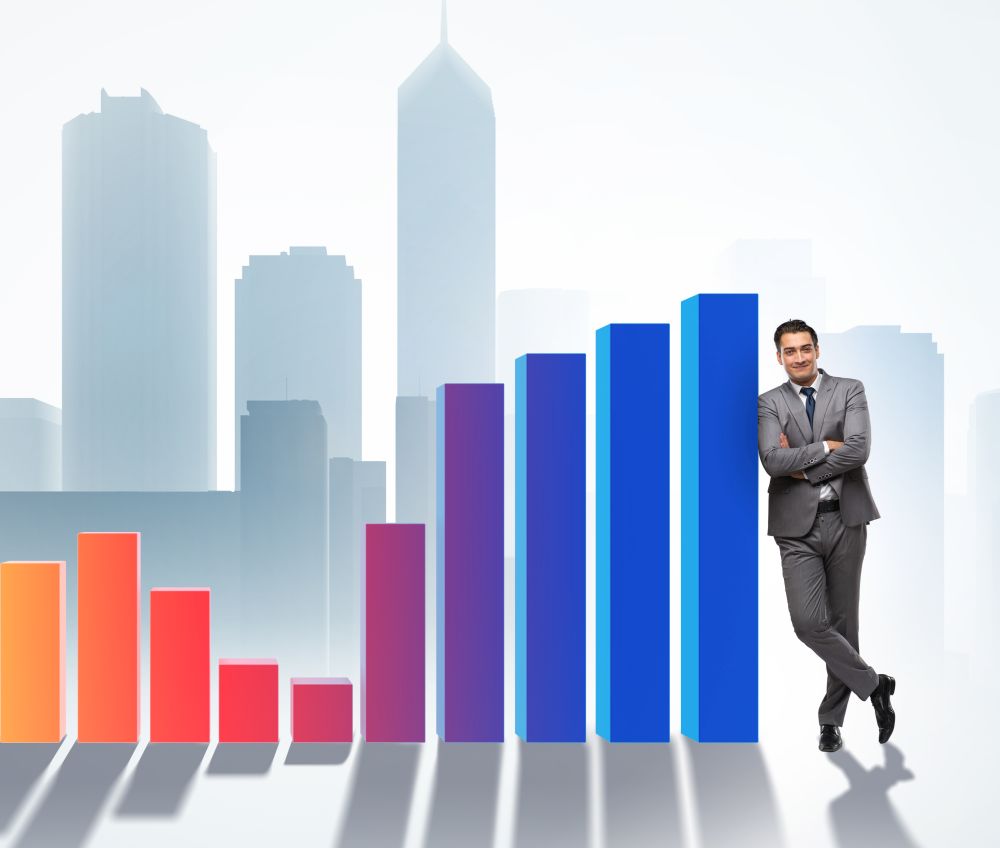 The young businessman in business concept with bar charts. Young businessman in business concept with bar charts