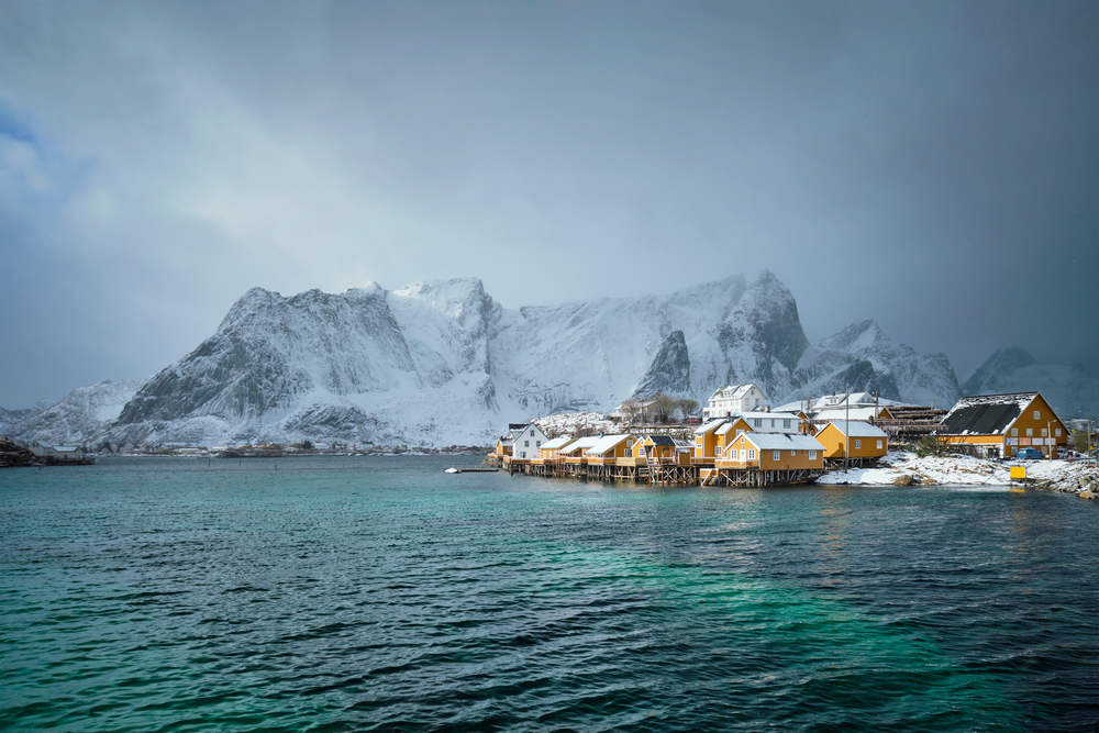 Yellow rorbu houses of Sakrisoy fishing village with snow in winter. Lofoten islands, Norway. Yellow rorbu houses, Lofoten islands, Norway