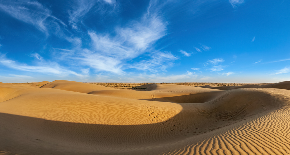 Panorama of dunes landscape with dramatic clouds in Thar Desert. Sam Sand dunes, Rajasthan, India. Panorama of dunes in Thar Desert, Rajasthan, India