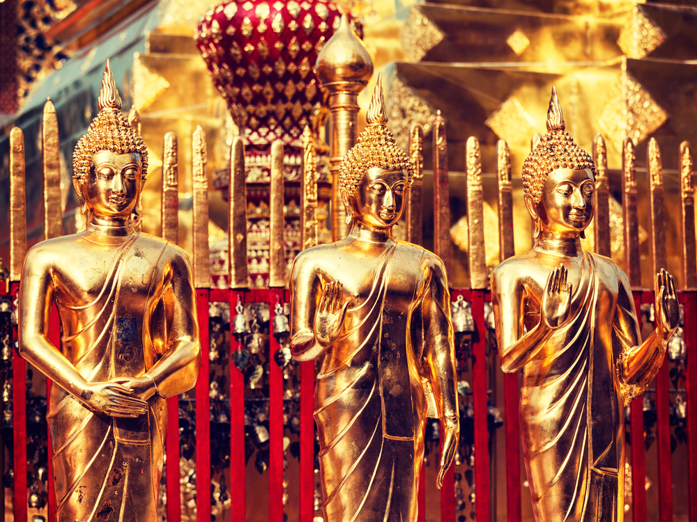 Vintage retro effect filtered hipster style image of Buddha statues in Wat Phra That Doi Suthep, Chiang Mai, Thailand. Gold Buddha statues in Wat Phra That Doi Suthep