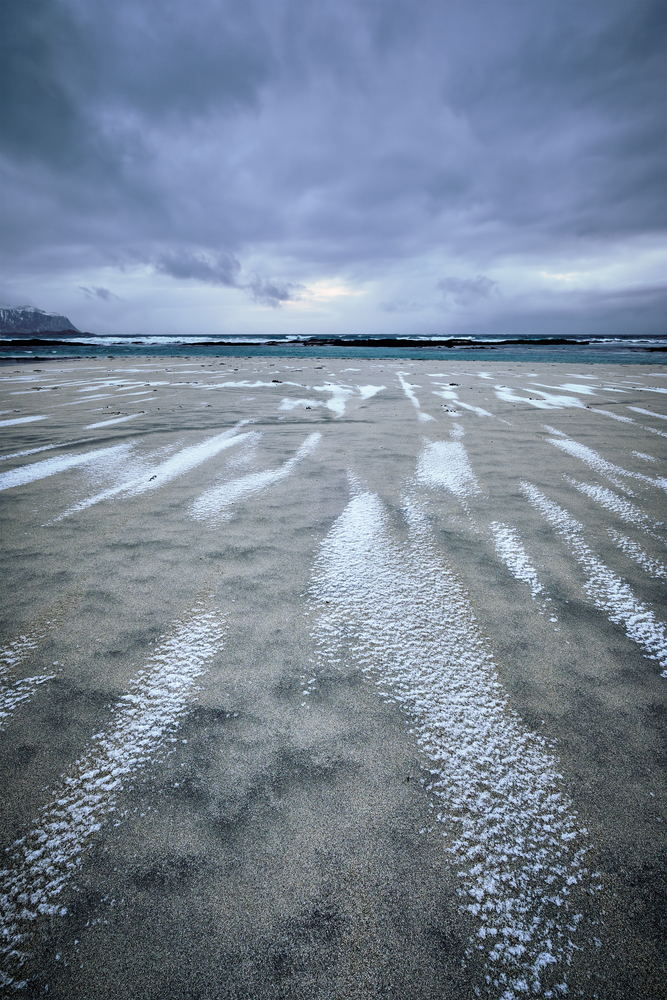 Rocky coast of fjord of Norwegian sea in winter. Skagsanden beach, Lofoten islands, Norway. Rocky coast of fjord in Norway