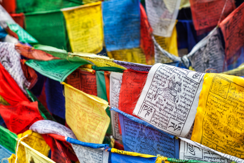 Tibetan Buddhism prayer flags (lungta) with Om Mani Padme Hum Buddhist mantra prayer. Leh, Ladakh, Jammu and Kashmir, India. Tibetan Buddhism prayer flags lungta