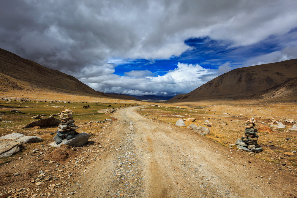 Road in Himalayas with stone cairns. Ladakh, Jammu and Kashmir, India. Road in Himalayas, India
