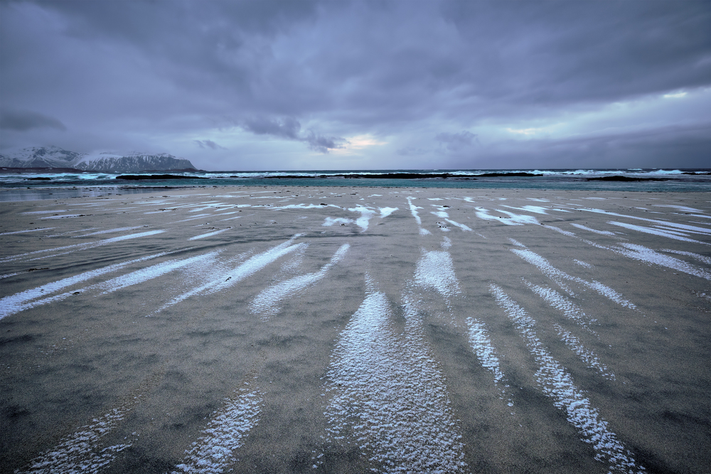 Rocky coast of fjord of Norwegian sea in winter. Skagsanden beach, Lofoten islands, Norway. Rocky coast of fjord in Norway