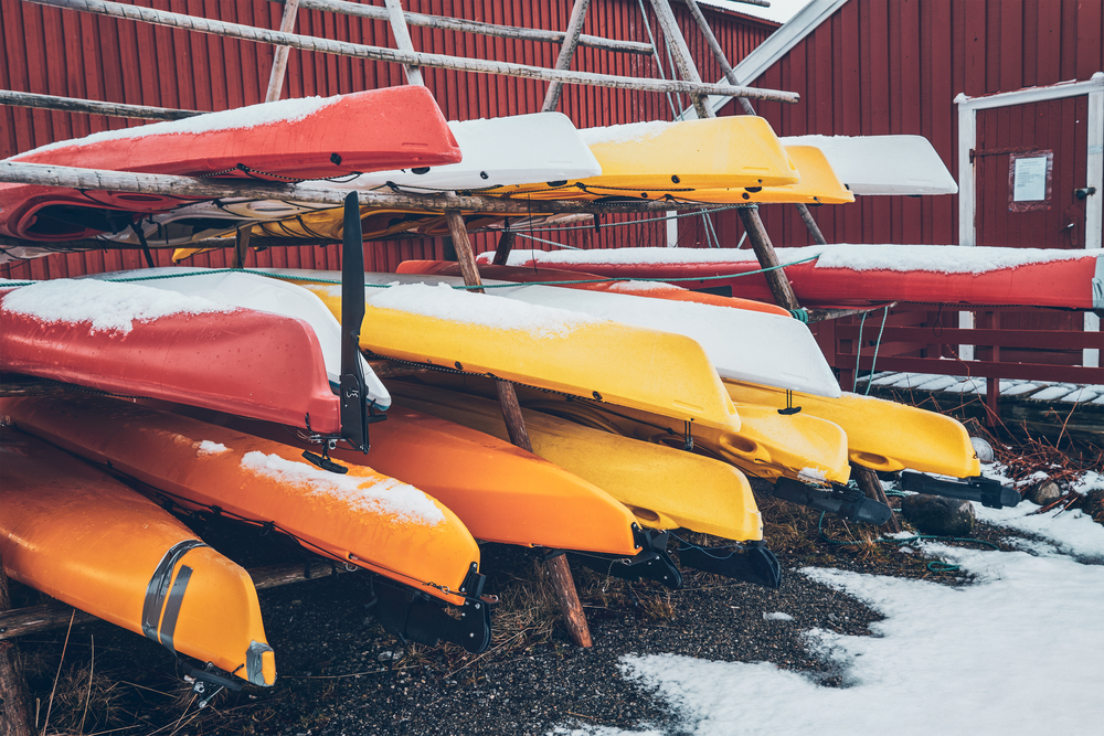 Kayaks stocked in winter in Reine fishing village, Lofoten islands, Norway. Kayaks in winter in Reine fishing village, Norway