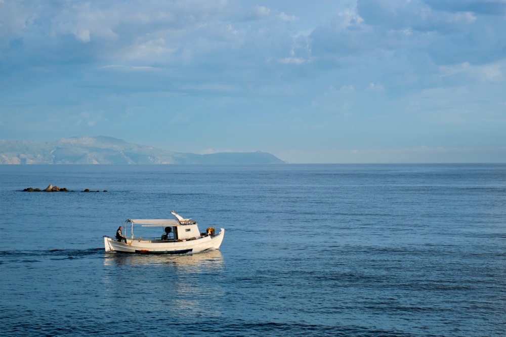 Fishing boat going to sea. Chania, Crete island, Greece. Fishing boat going to sea