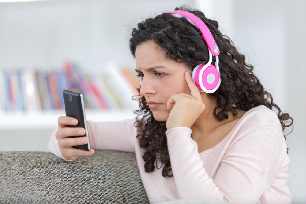 young woman with headphones using a smart phone