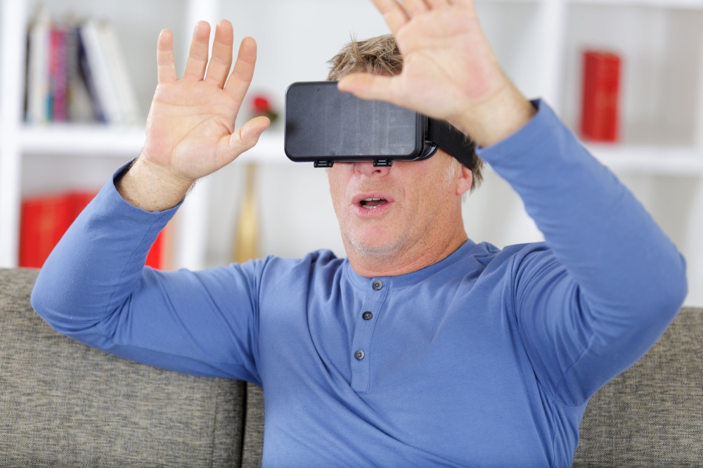 senior man with virtual headset at home