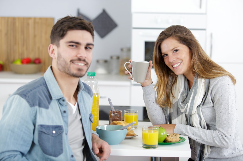 woman and man preparing breakfast in kitchen