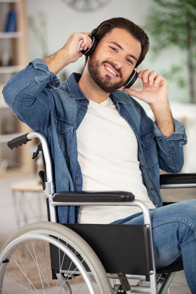 disabled man wearing headset and listening to music