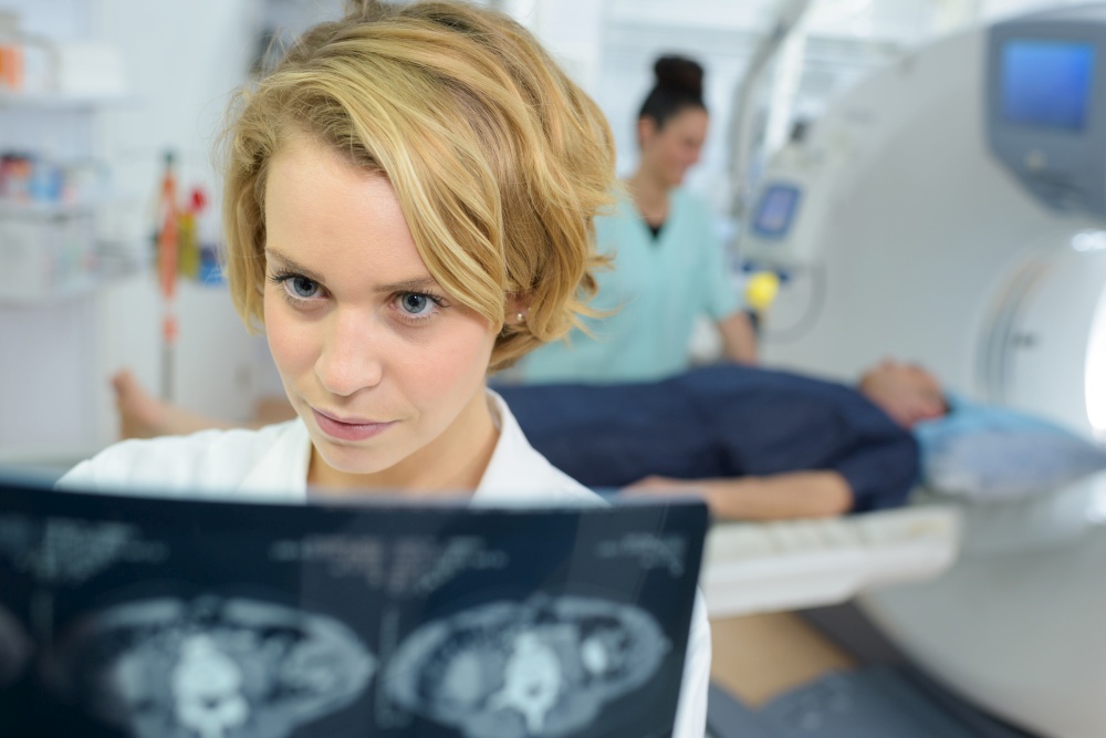 young female doctor looking at lungs x-ray image