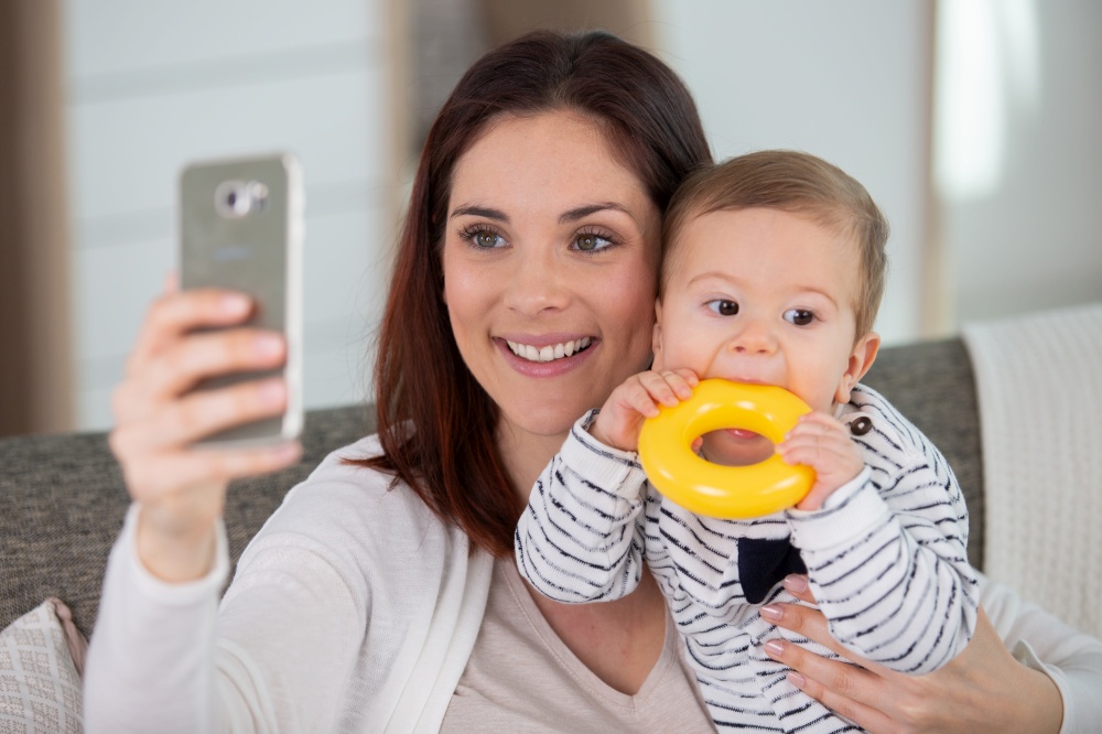mother with baby looking at the phone