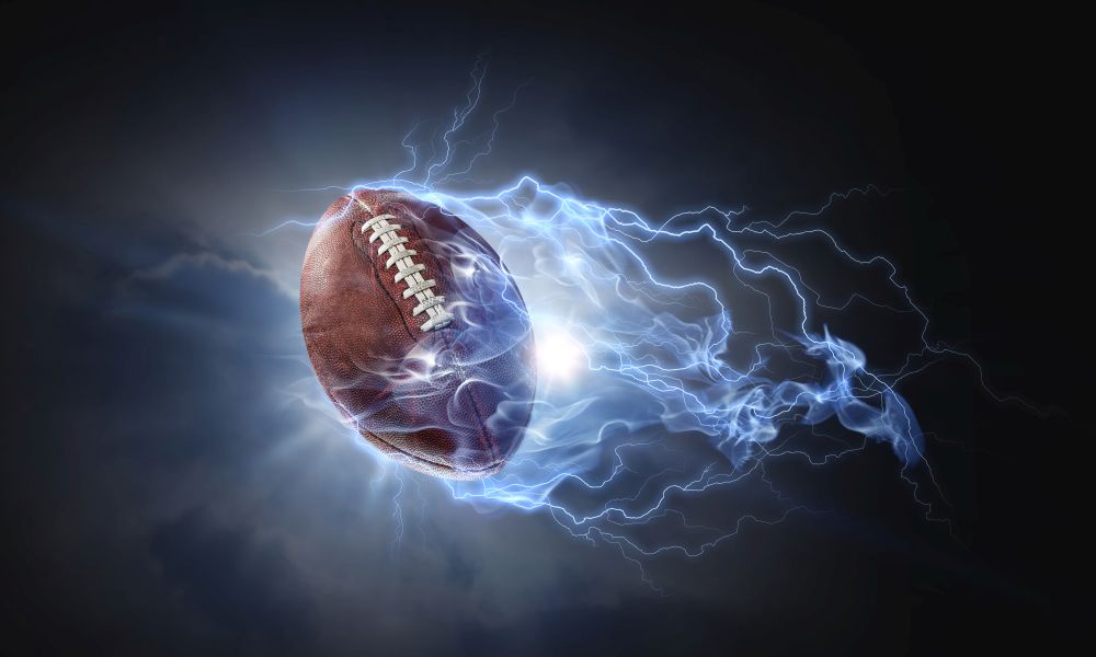 Rugby ball in lightning on a dark background. Mixed media. American football game
