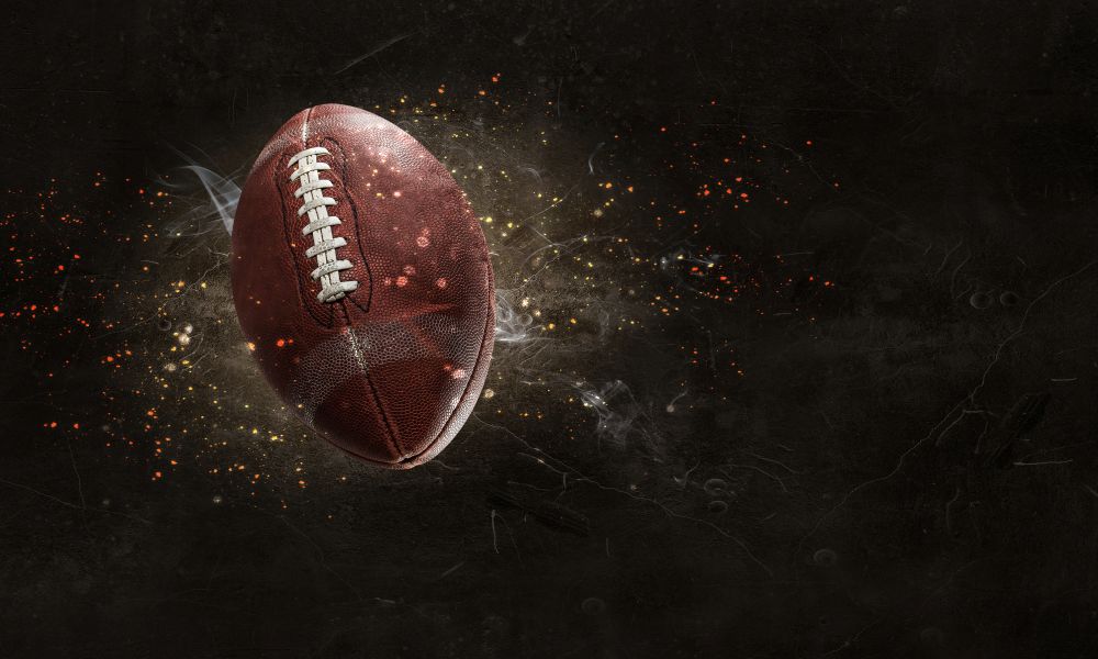 Rugby ball in lightning on a dark background. Mixed media. American football game