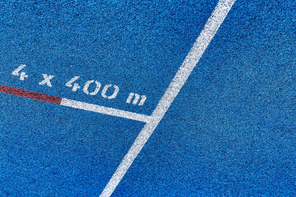 Close up of 400 meter sprint blue tracking field