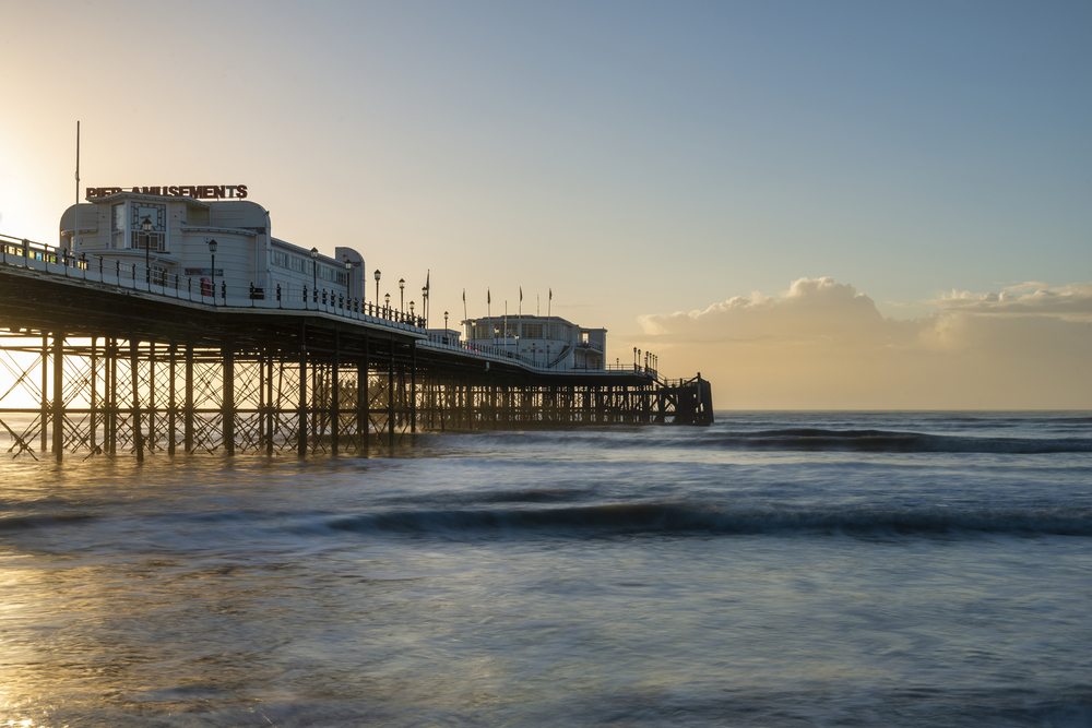 Beautiful sunrise landscape image of Worthing pier in West Sussex during Winter