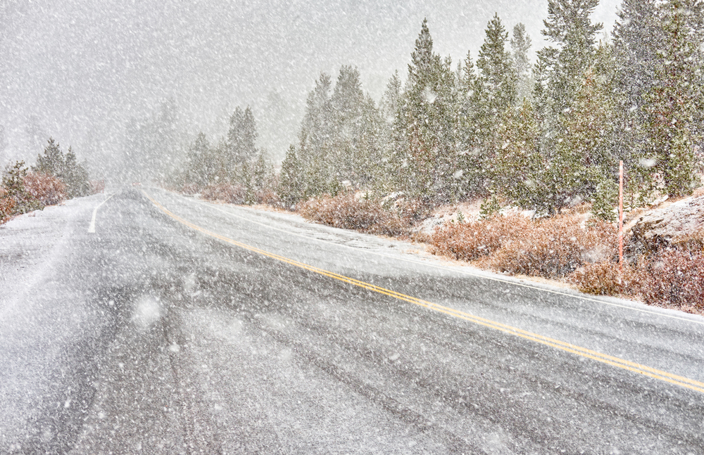 Snowstorm beginning in Yosemite National Park, Tioga Pass. Wet snowy road. California, USA.