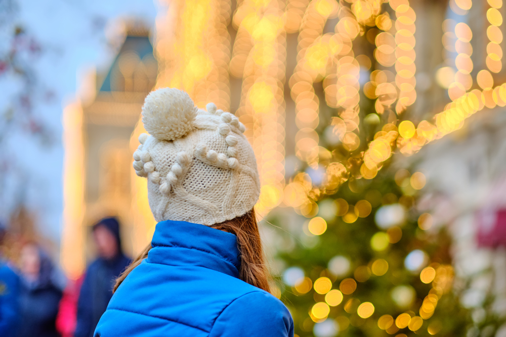 Woman looking at Christmas tree in Moscow city, Russia