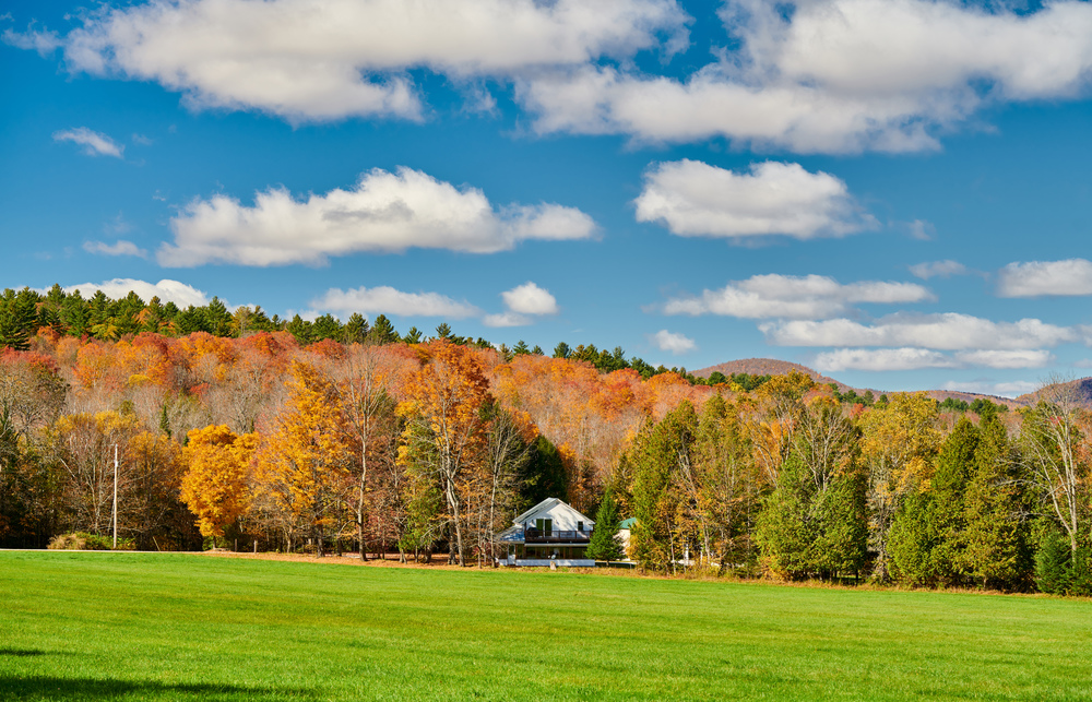 Autumn landscape with house in forest in Vermont, USA.
