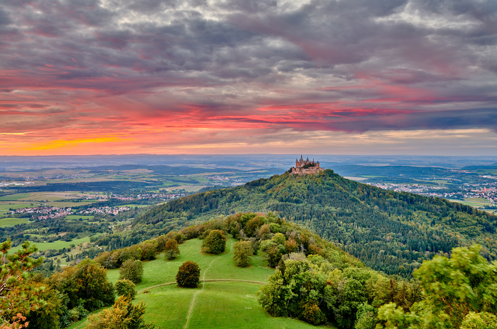 Hilltop Hohenzollern Castle on mountain top at sunset in Swabian Alps, Baden-Wurttemberg, Germany