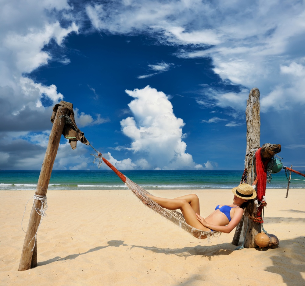 Woman in hammock on tropical beach at Tioman island, Malaysia