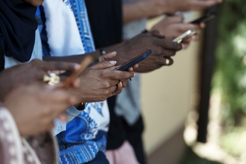 multiethnic students group on break using smart phones