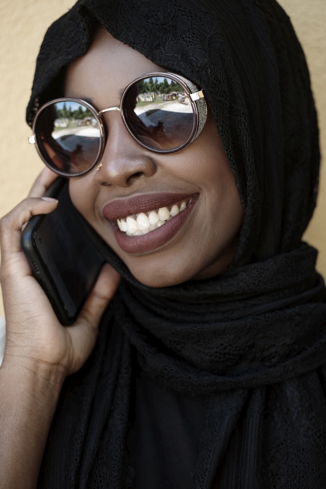 african  business woman using smart phone wearing traditional islamic clothes