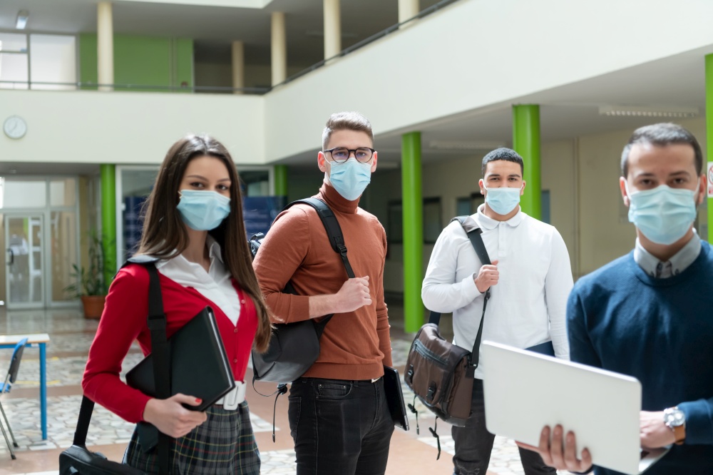 Multiethnic students group wearing protective face mask at university hallway new normal coronavirus time education concept